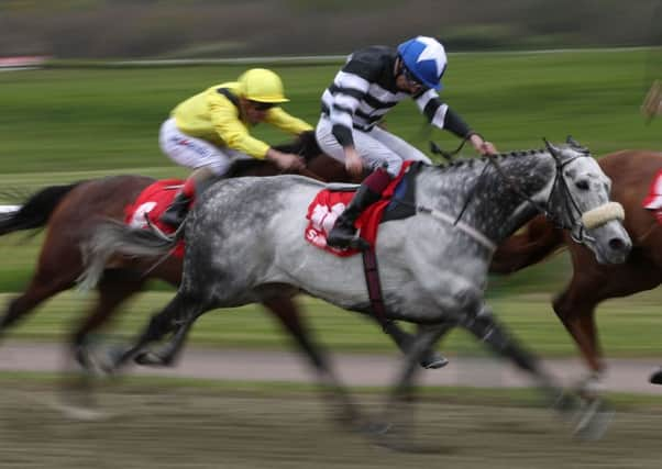 Sovereign and James Sullivan, right, on their way to winning The Sunbets All-weather Mile Championships Conditions Stakes  at Lingfield. Picture: John Walton/PA