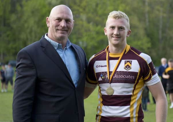 Scotland coach and former Huddersfield player Vern Cotter congratulates record-breaking fly-half Chris Bell, having presented him with his championship medal.