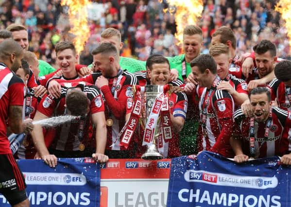 Sheffield United's players celebrate with the League One trophy (Picture: David Klein/Sportimage)