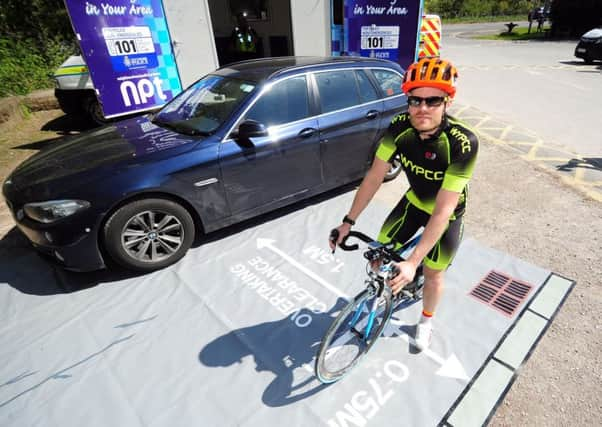 Launch of West Yorkshire Police Safe Pass Cycling Scheme, at Bramhope, Leeds..PC Tom Allen showing the safe distance to car.3rd May 2017 ..Picture by Simon Hulme