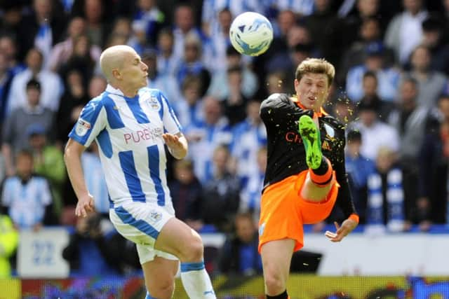 Sheffield Wednesdays Adam Reach, seen on Sunday duelling with Huddersfield Towns Aaron Mooy, is expecting a tense Championship play-off semi-final second leg tonight (Picture: Steve Ellis).