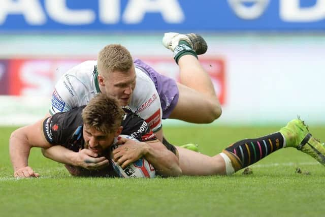 St Helens' Tommy Makinson scores a try under pressure from Hull FC's Chris Green (Photo: PA)