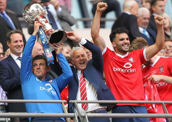 Darren Casket and Gary Mills lift the trophy.