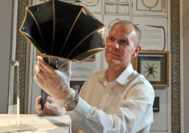 Curator Robin Diaper with an amplification horn mistaken by one child as a device for making crumpets, on show as part of Bill Baileys Cabinet of Curiosities exhibition at Hull Maritime Museum.  Picture by Tony Johnson.