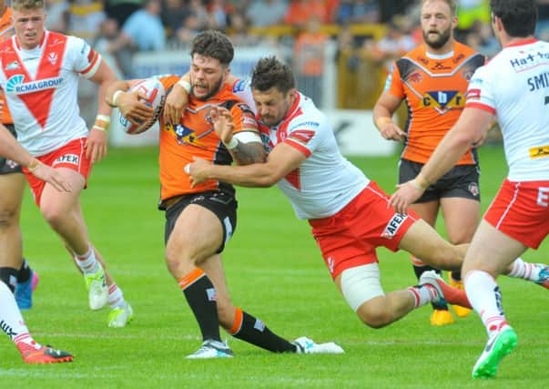 Alex Foster is tackled by Jon Wilkin.