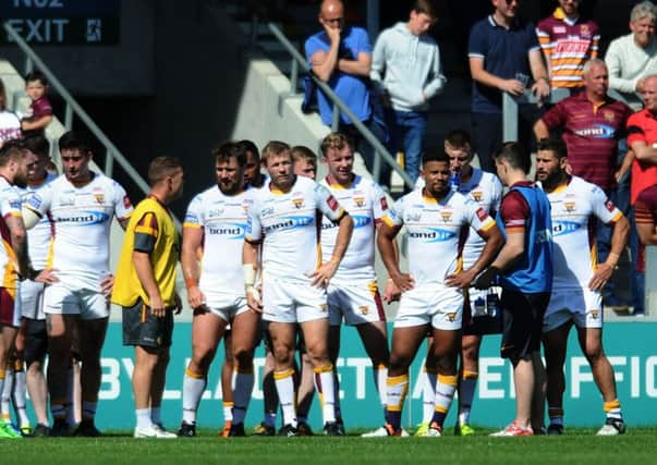 Dejection for Huddersfield's players.