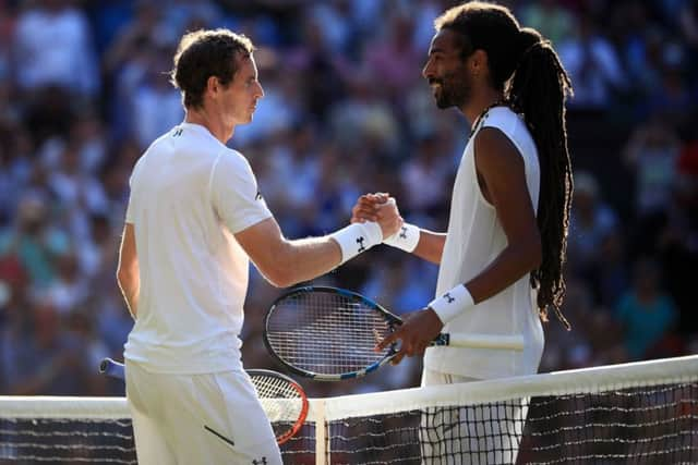 Andy Murray celebrates victory over Dustin Brown.