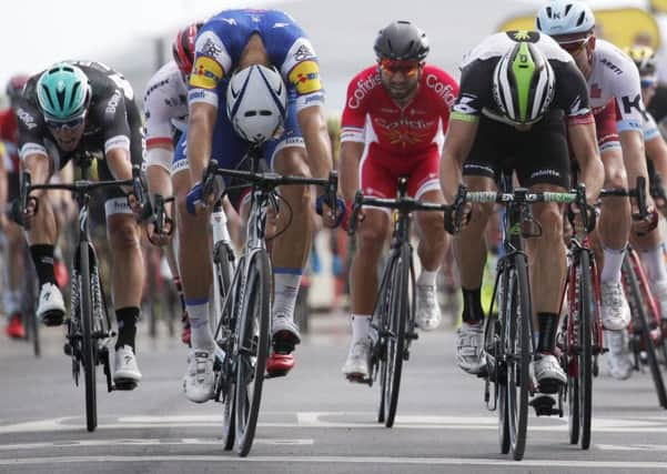 Germanys Marcel Kittel bows his head as he crosses the line ahead of Norways Edvald Boasson Hagen (Picture: Christophe Ena/AP).