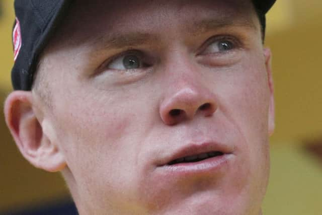 Britain's Chris Froome, wearing the overall leaders yellow jersey, on the podium after the ninth stage of the Tour de France cycling race over 181.5 kilometers (112.8 miles) with start in Nantua and finish in Chambery, France, Sunday, July 9, 2017. (AP Photo/Christophe Ena)