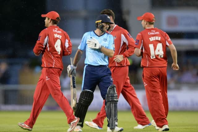 Adam Lyth walks after being caught by Arron Lilley off the bowling of Ryan McLaren at Old Trafford. Picture: Bruce Rollinson