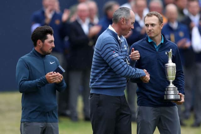 Runner-up Matt Kuchar casts an envious glance at the trophy as he congratulates Jordan Spieth (Picture: Andrew Matthews/PA Wire).