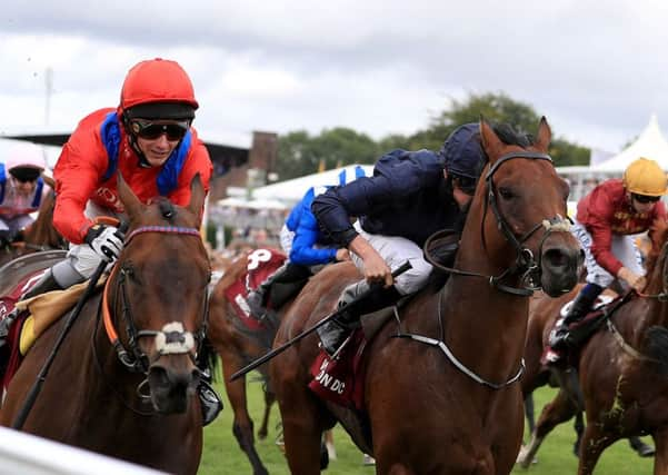 Take Cover, left, ridden by jockey David Allen, left, on the way to winning the Qatar King George Stakes during day four of The Qatar Goodwood Festival last July.