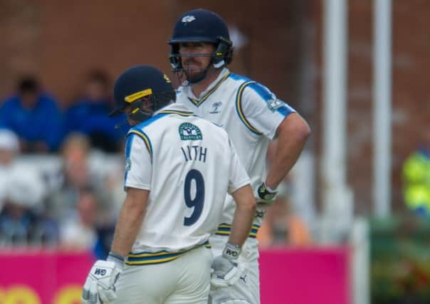 Tough going: Ryan Sidebottom chats with Adam Lyth during the County Championship Division One matchagainst Essex at Scarborough. 
Picture: James Hardisty