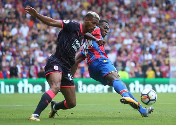 In at the double: Huddersfield Town's Steve Mounie  and Crystal Palace's Timothy Fosu-Mensah battle for the ball.