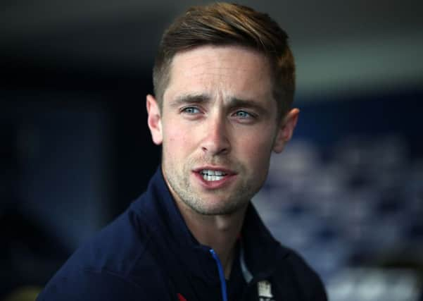 England's Chris Woakes speaks to the media.