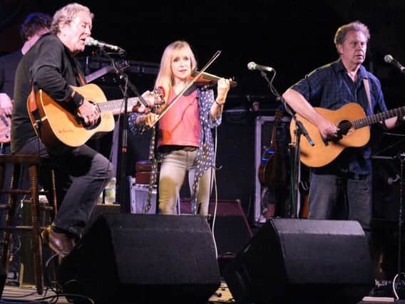 Magna Carta founder Chris Simpson, left, on stage with members of his legendary band.