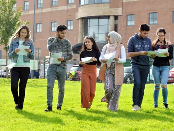 Juliana Kalniana, A*, Yusuf Khan, 9A*, Hansa Khan, 8A*, Iqra Hussain, 9A*, Arman Khan, 9A* and Alex Funk 9A* looking at their results at Dixons Trinity Academy, Bradford. Picture Bruce Rollinson