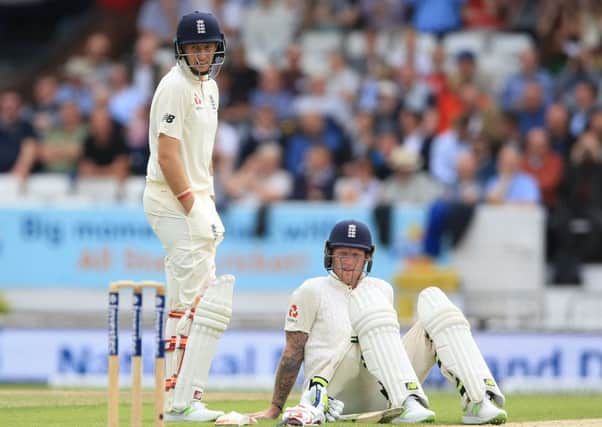 England's Joe Root (left) and Ben Stokes wait for the sightscreen to be adjusted during the Test match at Headingley. Picture: Nigel French/PA