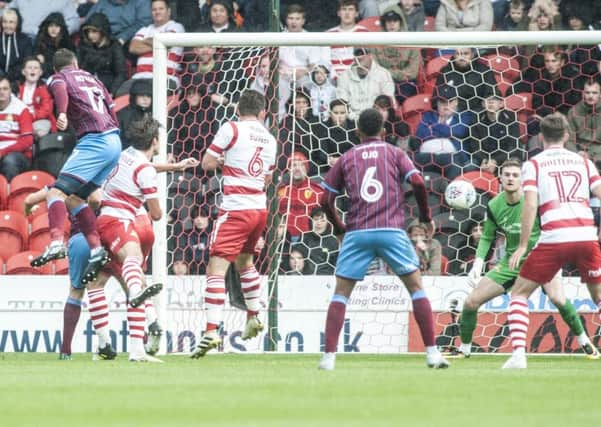 Scunthorpe's Lee Novak rises to score the winner.