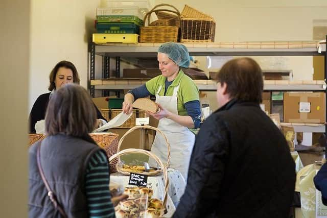 Jessica Sellers serving a customer at the Side Oven Bakery