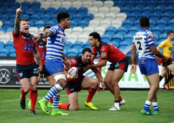 Featherstone's Josh Walters congratulates try scorer Frankie Mariano.