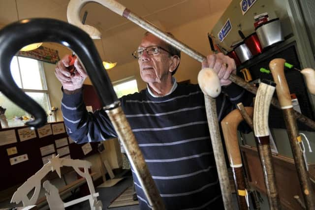 Bob Hodge at work on the wooden walking sticks.