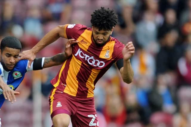 HEAT OF BATTLE: Bradford City's Nathaniel Knight-Percival face a tough battle against Doncaster's John marquis. Picture: Tony Johnson.