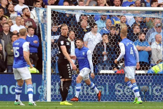 Gary Hooper, second right, runs away to celebrate the first of his two goals in Sheffield Wednesdays 3-0 defeat of Leeds United in yesterdays Championship match at Hillsborough (Picture: Tony Johnson).