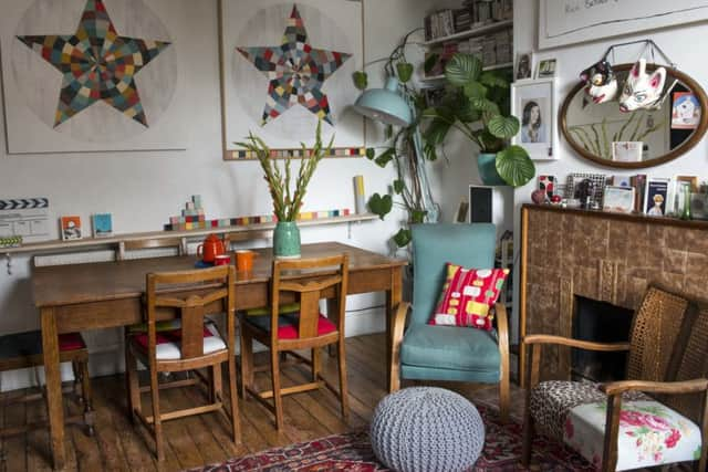 The sitting/dining room with vintage furniture . The star prints are by Georgia.