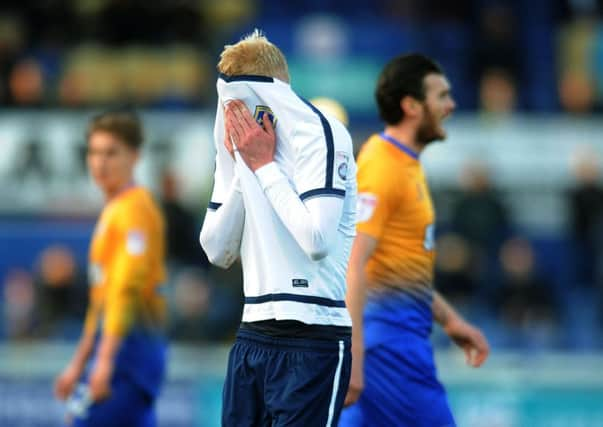 Guiseleys Darren Holden covers his face in embarrassment after being red-carded against Mansfield Town (Picture: Jonathan Gawthorpe).