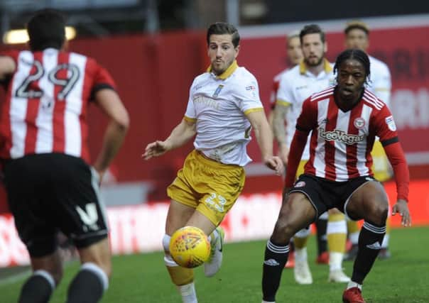 Sheffield Wednesday's Sam Hutchinson battles for posession at Griffin Park. Picture Steve Ellis