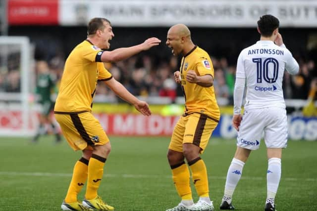 Sutton United players celebrate their win over Leeds United in the FA Cup last season.