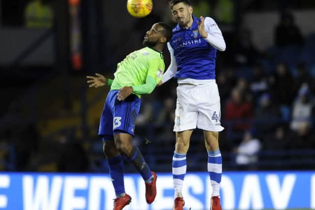 In command: Owls defender Frederico Venancio beats Cardiff's Junior Hoilett. Picture: Steve Ellis