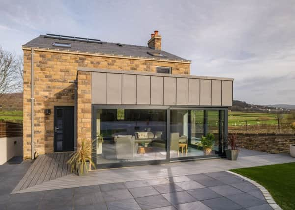 The rear of the house with the upper ground floor living space leading onto the garden.