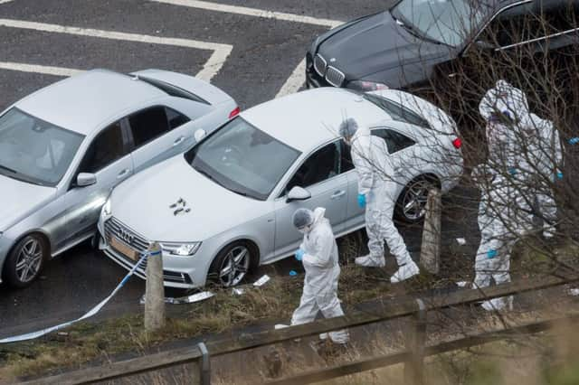 Date:3rd January 2017. Picture James Hardisty. Police incident on the Ainley Top slip road Huddersfield, West Yorkshire off the M62 junction 24 where one man has been shot dead by police, pictured West Yorkshire Police forensic teams examining the cars at the scene.