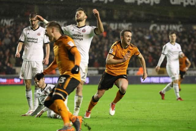 Diogo Jota celebrates his goal with team mate Barry Douglas.