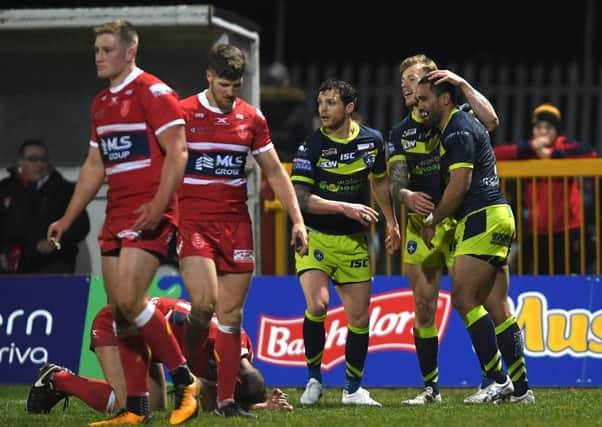 Wakefield Trinity's Bill Tupou celebrates his try with team-mates as deflated Hull KR players turn aside. PIC: Anna Gowthorpe/SWpix.com