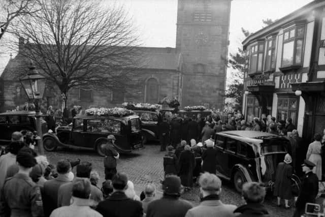 Mourners stand in silence as the coffin of Roger Byrne, Manchester United captain, is taken from Flixton Parish Church, near Manchester, for the last journey to the crematorium.