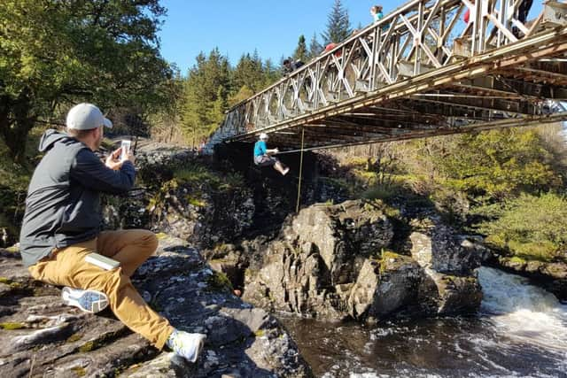 Flashpackers bridgeswinging in the Scottish Highlands. PA Photo/Flash Pack.