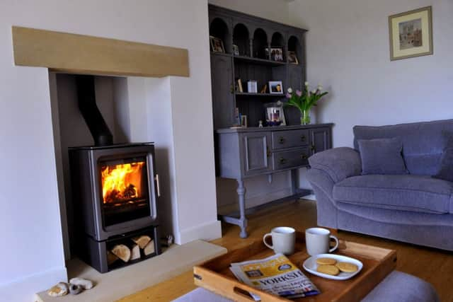 The ground floor sitting room with wood-burning stove and the dresser painted by Carol.