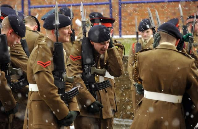 Junior soldiers endure a hail storm as they line up to march on to the  parade square for their Graduation Parade.