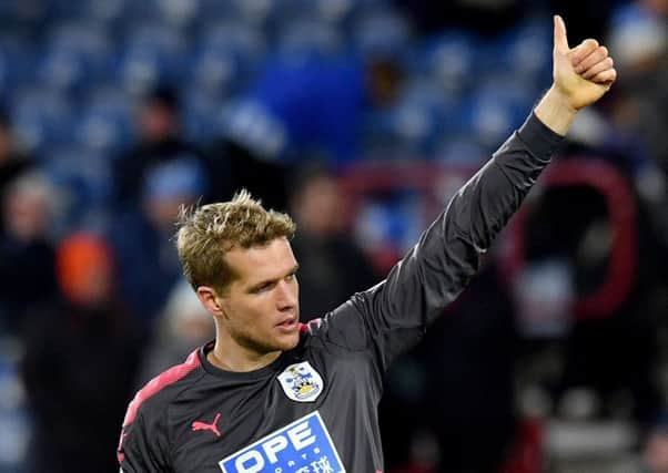 Jonas Lossl, seen acknowledging Huddersfield Towns fans, says they are playing their part in the Terriers fight for survival (Picture: Anthony Devlin/PA).