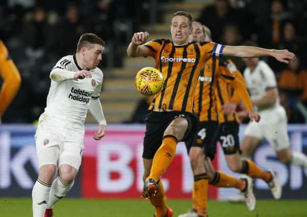 Sheffield Uniteds John Fleck, left, and Hull Citys Michael Dawson vie for the ball during last nights Championship match (Picture: Simon Bellis/Sportimage).