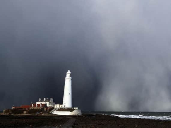 A snow storm over St Mary's Lighthouse in Whitley Bay, as heavy snowfall is affecting roads across the UK after several centimetres fell in some parts over the night. PA