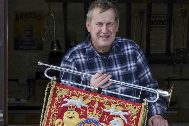 Richard Smith of Smith Watkins with one of his previously completed ceremonial fanfare trumpets.