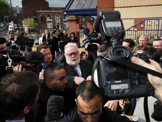 Paul Flowers, centre, has been banned from the financial services industry.