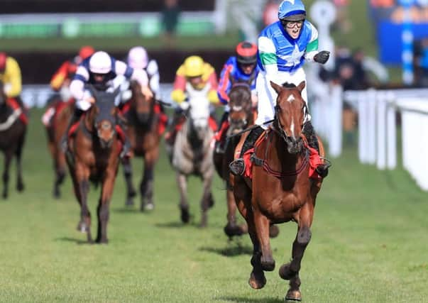 Jockey Lizzie Kelly on board Coo Star Sivola  celebrates winning the Ultima Handicap.