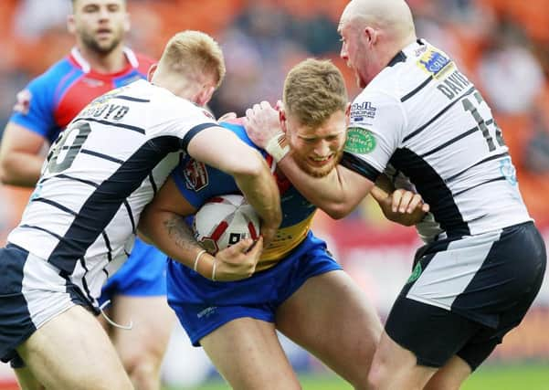 London's Lewis  Bienek tackled by Featherstone's Jack Ormondroyd and John Davis.