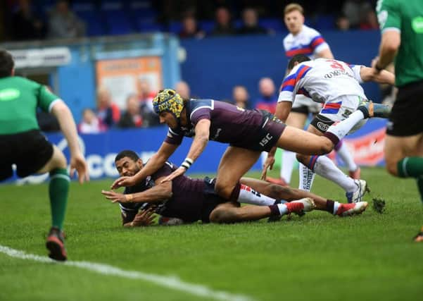 Rhinos captain Kallum Watkins scores the opening try, the first of two against Wakefield. He also kicked four goals. PIC: Jonathan Gawthorpe