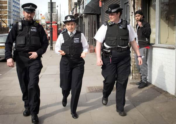 Metropolitan Police Commissioner Cressida Dick (centre) walks with officers through Stoke Newington in north London, after a recent spate of gang violence in which several teenagers died.